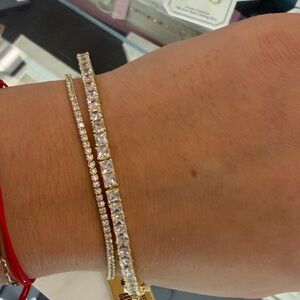 Elegant Gold and Silver Tennis Bracelet the one on the left, thicker